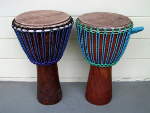 Two rebuilt African djembe hand drums.